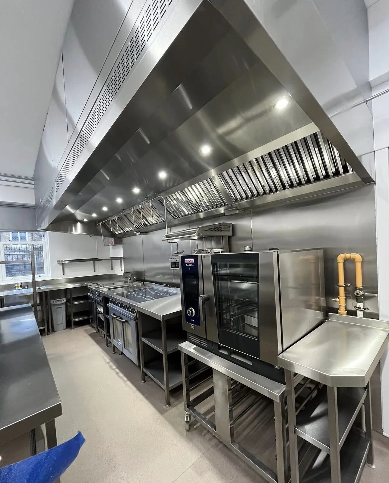 Commercial kitchen with exhaust canopy and cooking equipment