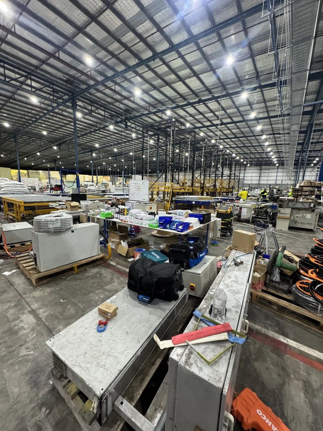 Electrical installation work in progress on a plant floor